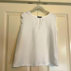 White chiffon tank with scallop edges on the arm openings